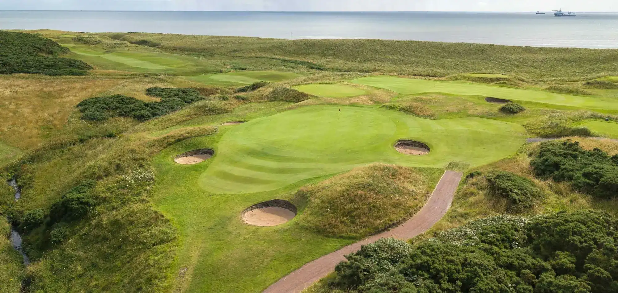 Murcar Links green and bunkers from above, with the sea beyond